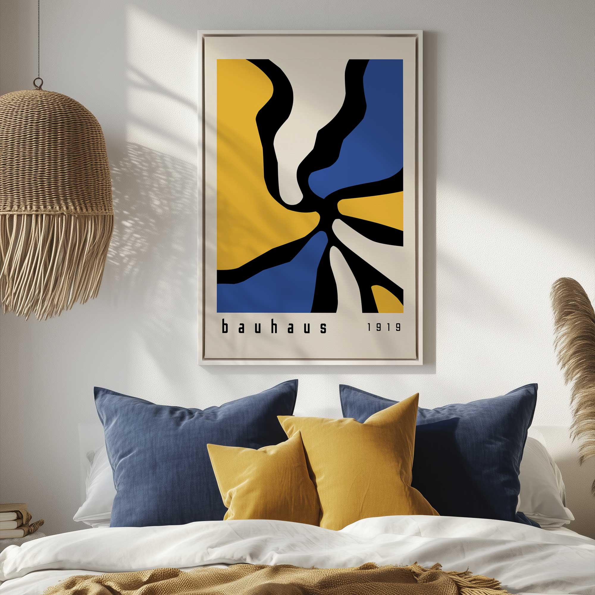 Twisted yellow and blue Bauhaus canvas print in a white floater frame hanging above a bed