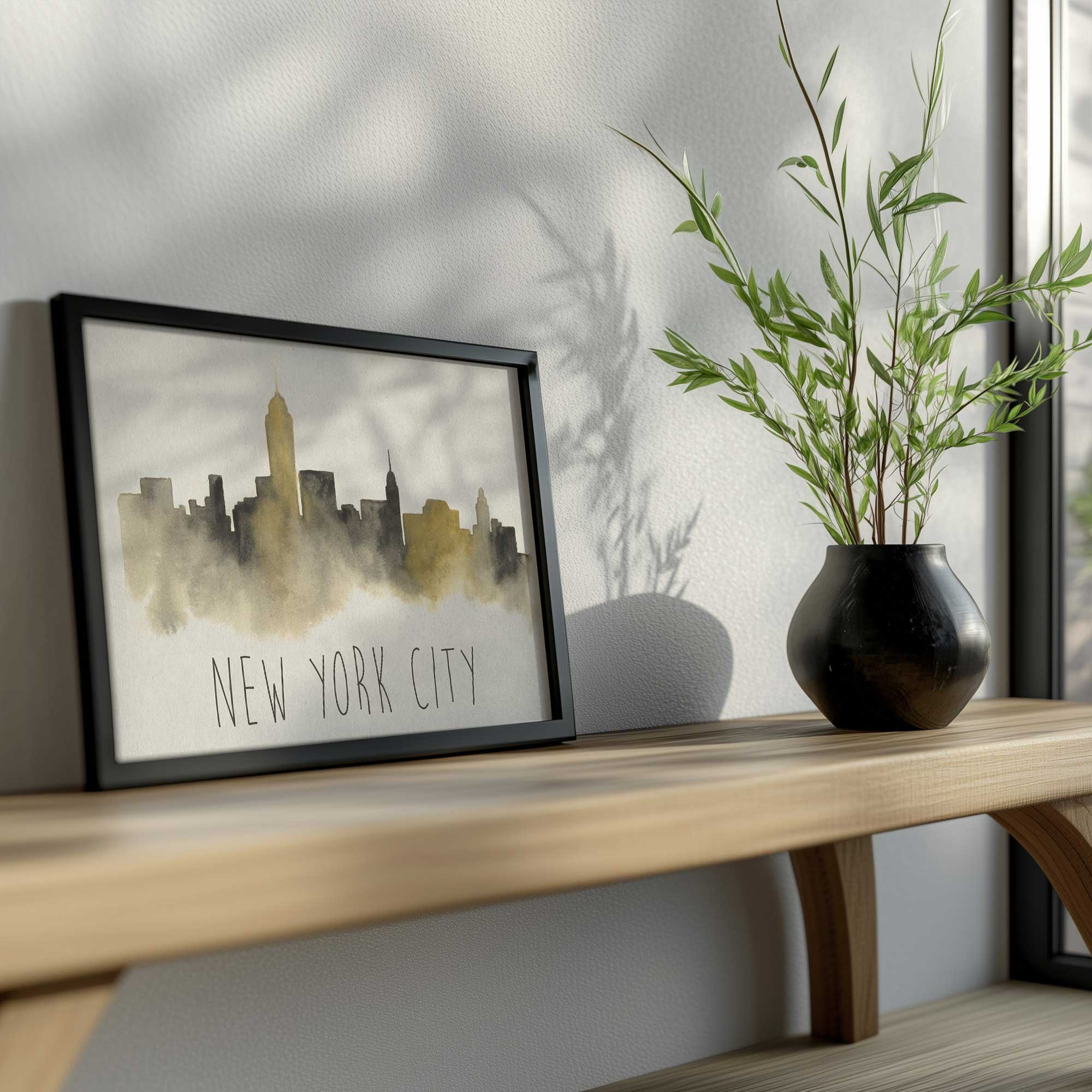New York City skyline art print in a black frame on a bench