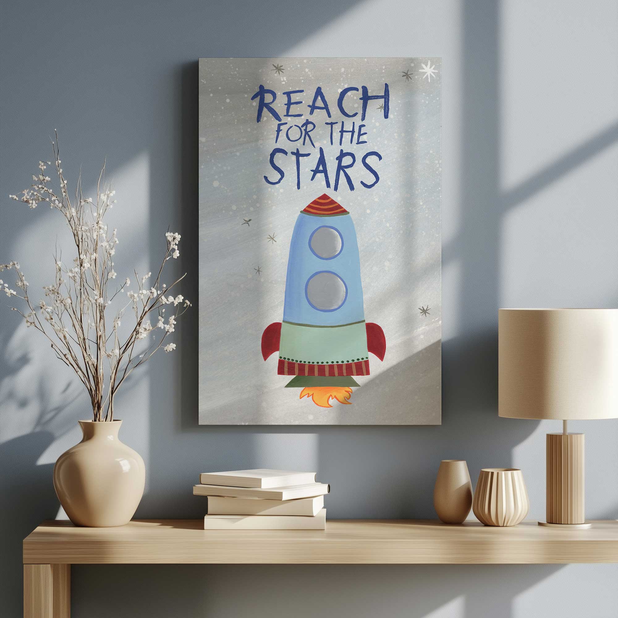 reach for the stars rocket art canvas print hanging above a desk in a blue room