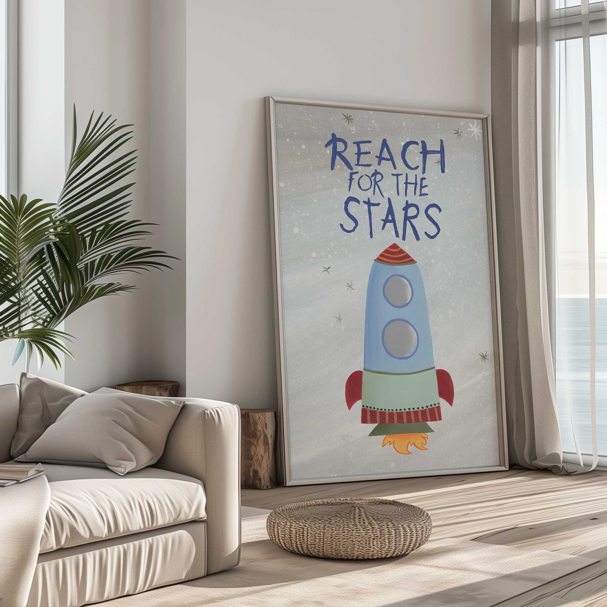 Reach for the stars rocket art print leaning against the wall in a neutral living room