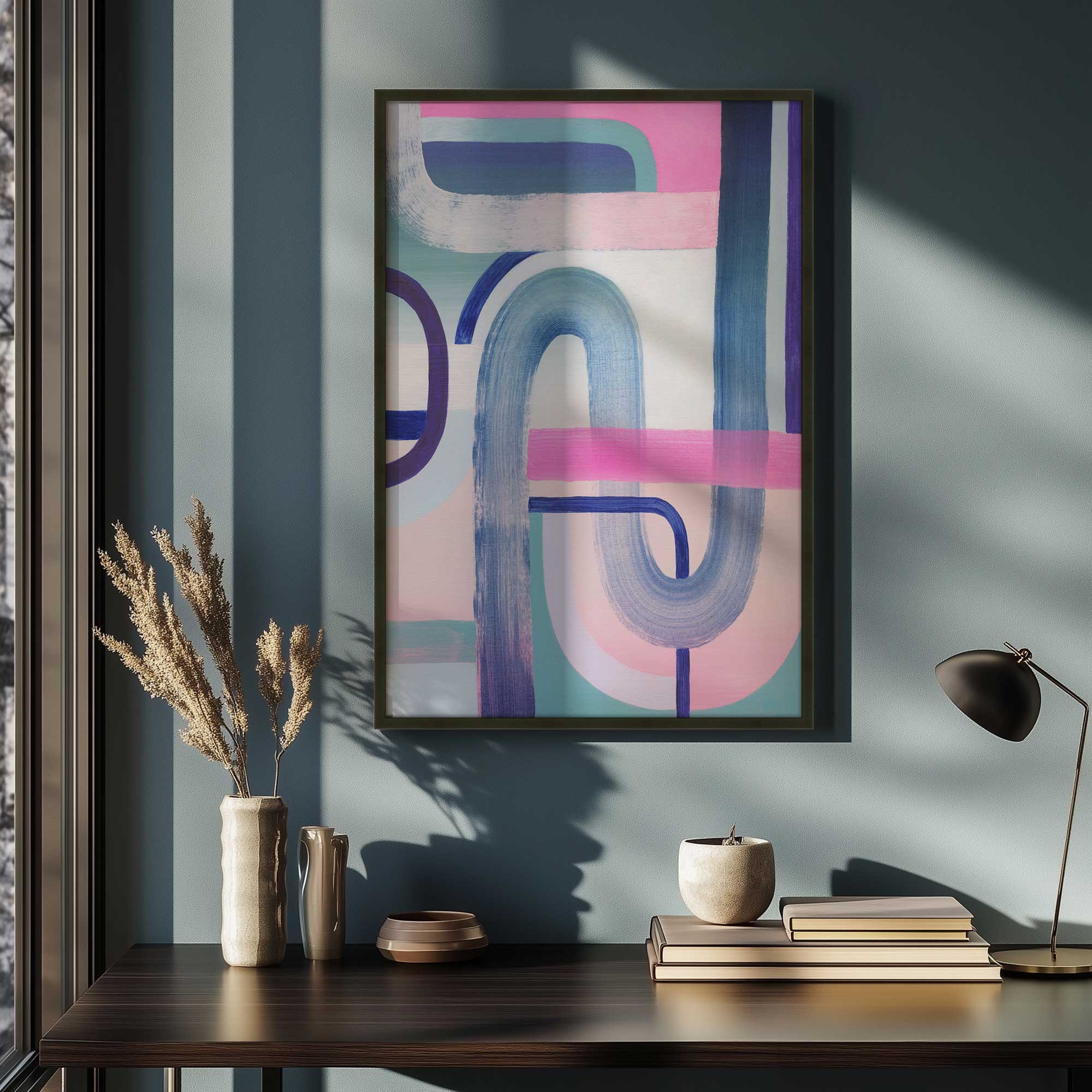 curves and candy stripes II art print hanging above old books and a vintage lamp