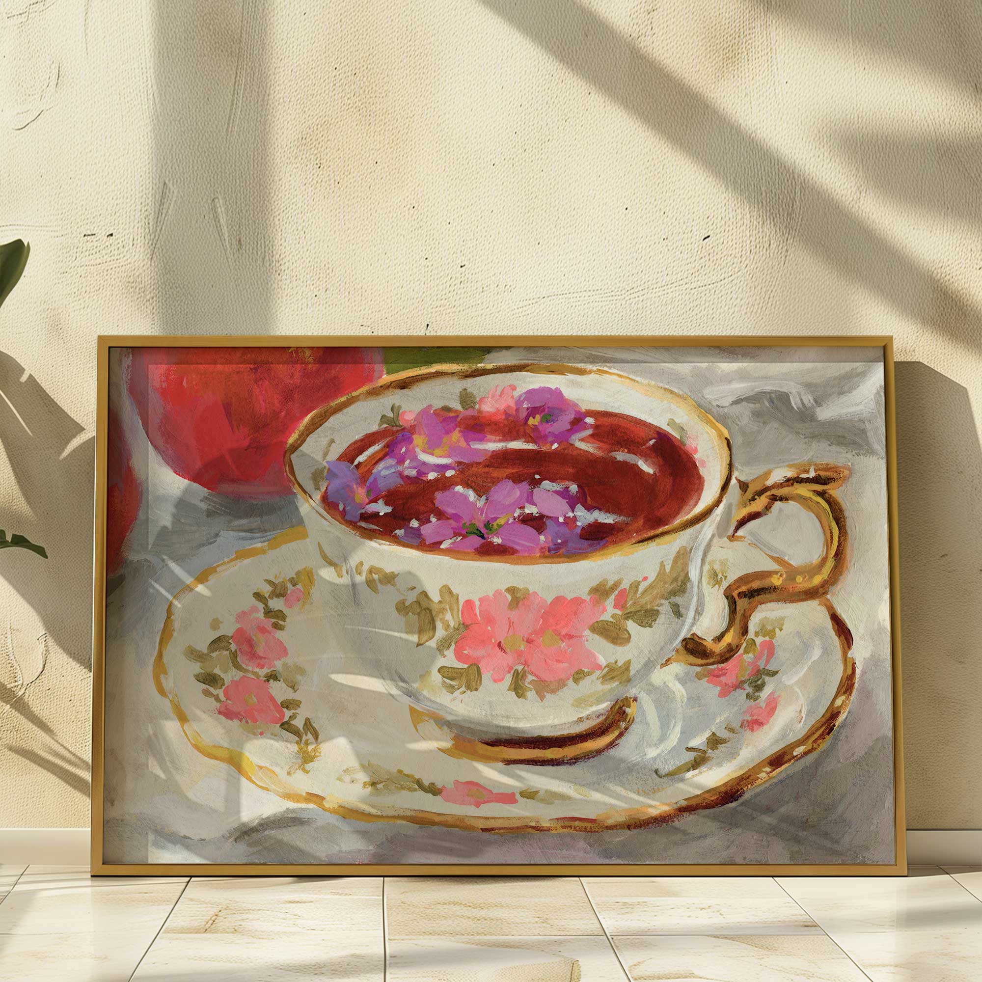 vintage floral teacup with petals floating in brew art print in a gold frame leaning against a wall