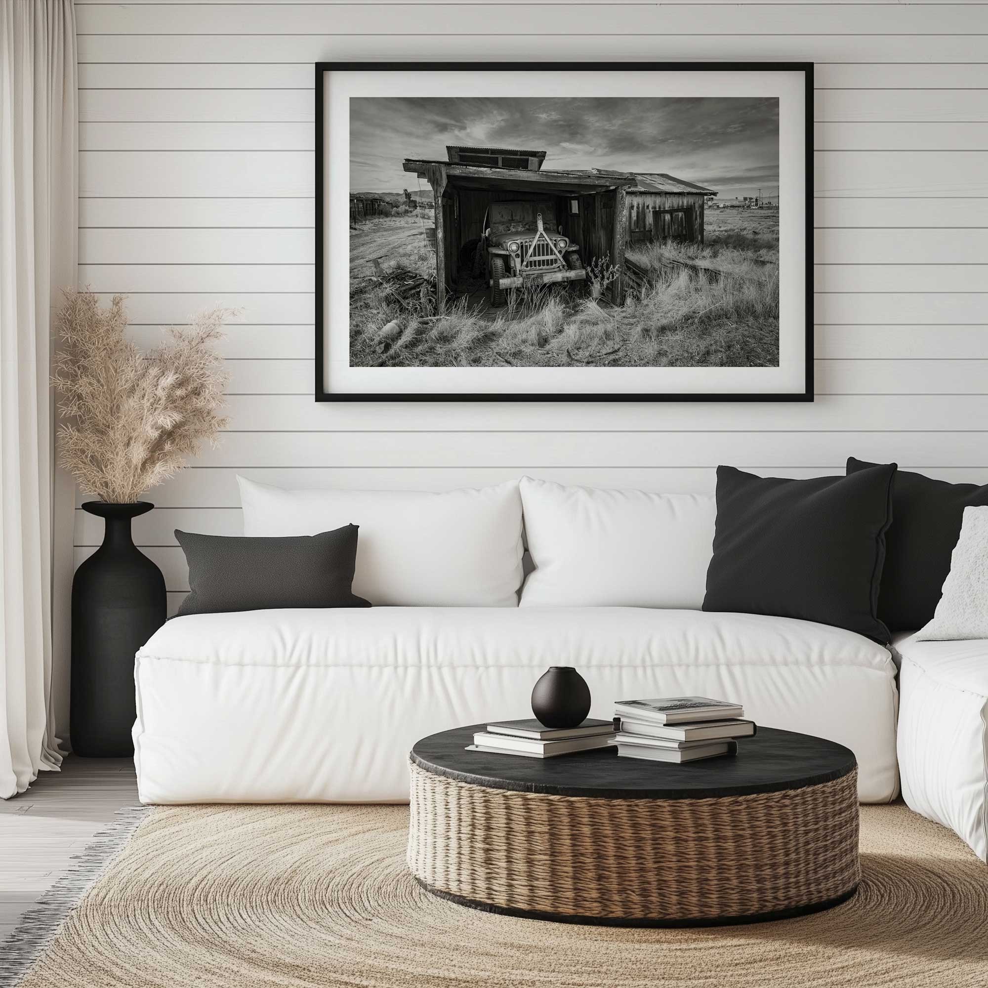 Desert Garage Days paper print in a black frame hanging above a white couch