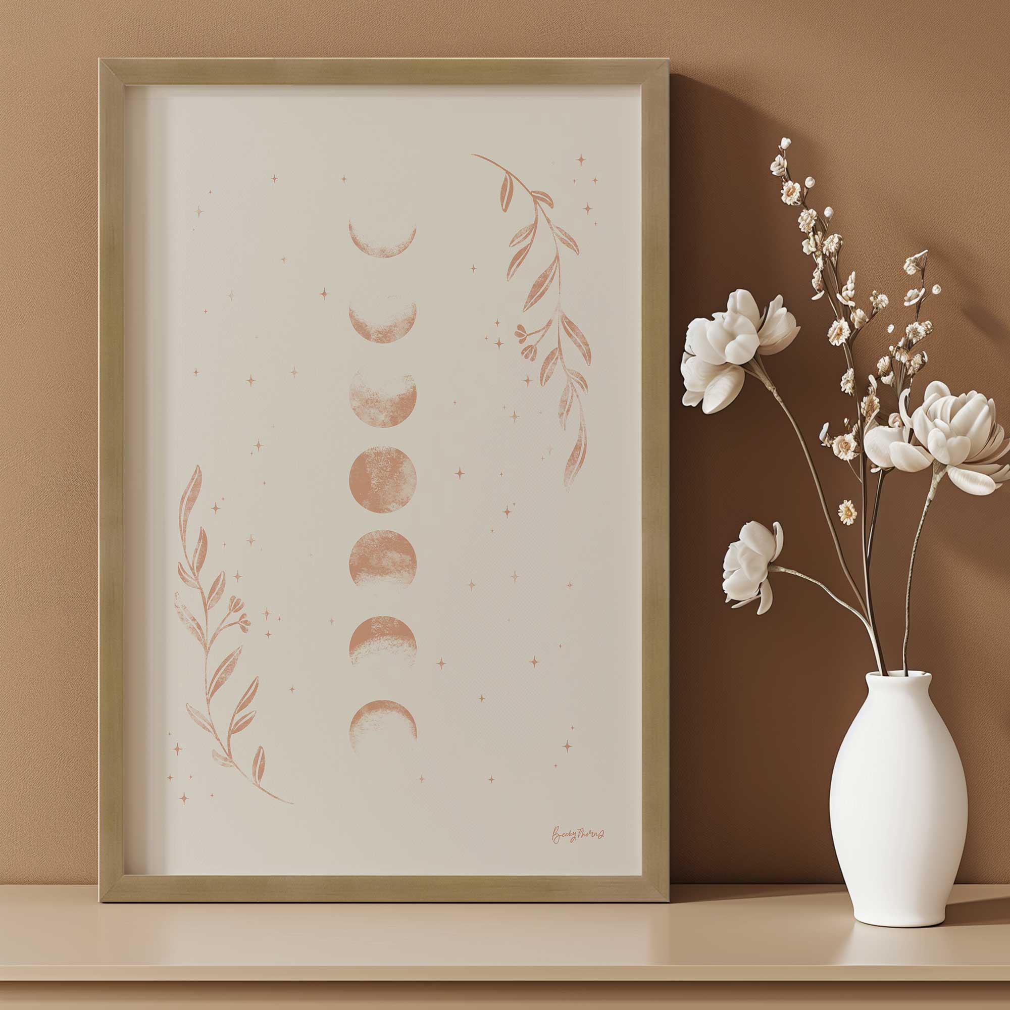 moon phase magic art print next to a small vase of flowers