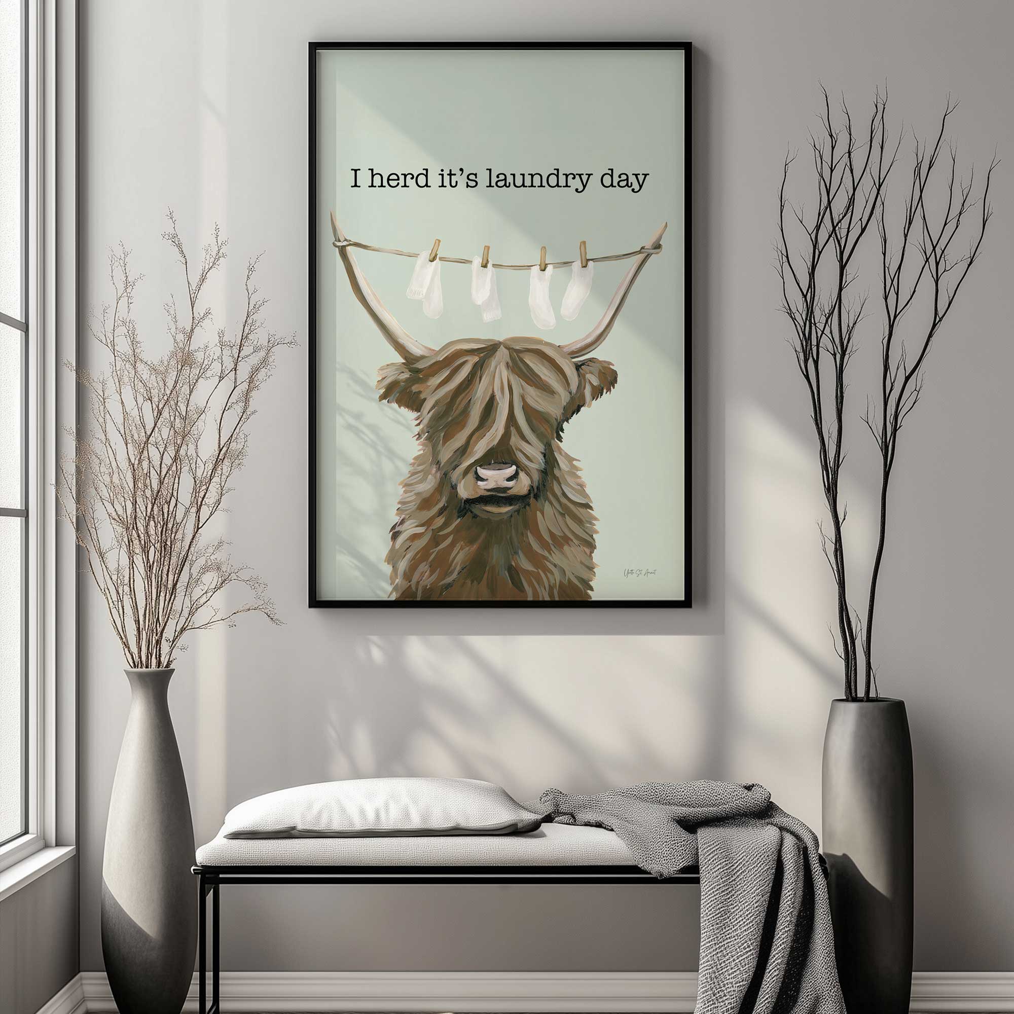 I herd it's laundry day fluffy cow laundry art print hanging above a bench